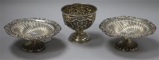 A pair of Victorian embossed and fluted silver sweetmeat dishes, London 1892, Sibray Hall & Co and an embossed pedestal bowl, 11.2oz